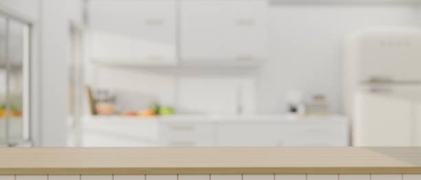istock Mockup space on a wooden tabletop against a barred, minimal white kitchen as a background 1542312176