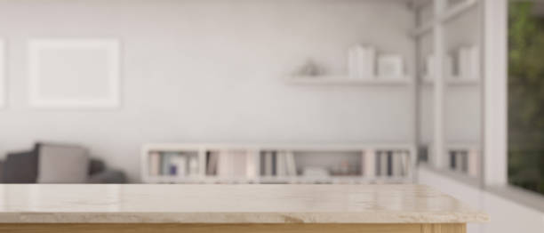 istock Copy space on an empty marble tabletop with a blurred, minimalist white living room as a background. 1542312178