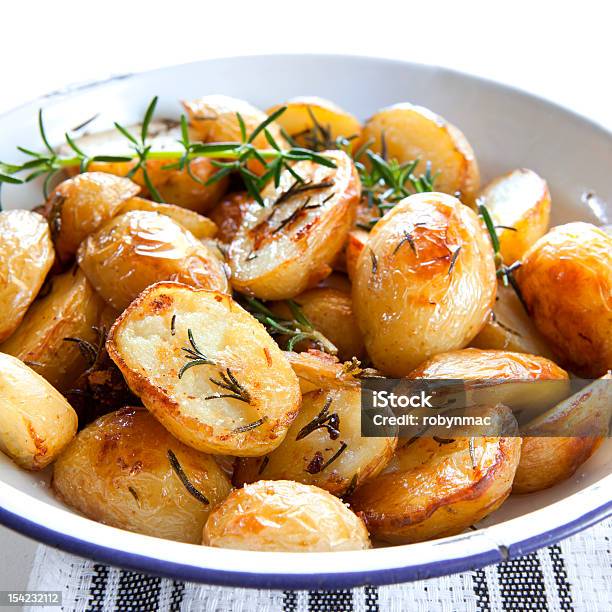 Dish With Roasted Potatoes And Garnish Stock Photo - Download Image Now - Roasted Potatoes, Baked Potato, Herb