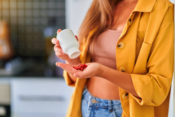 istock Woman taking medicine at home 1542331258