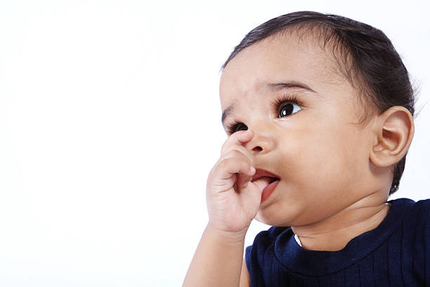 индийский милый ребенок - finger in mouth стоковые фото и изображения