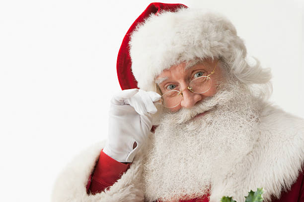 Close up of Santa claus touching his eye glasses Close up of Santa claus touching his eye glasses looking at camera, horizontal composition, Isolated on a white background santa stock pictures, royalty-free photos & images