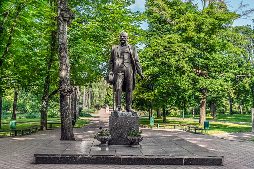 Trostyanets, Sumy Oblast, Ukraine - June 18, 2023: Monument Tchaikovsky in Trostyanets central park. Male statue among the summer greenery in the city garden