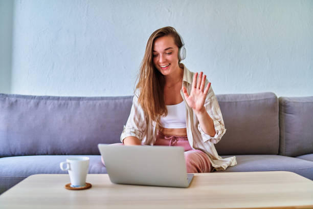 istock Young happy smiling cute satisfied girl student practicing remote online foreign language lesson 1542364094