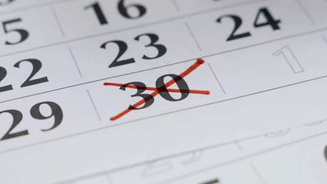 In the calendar, the 30th number is boldly crossed out with a red marker.