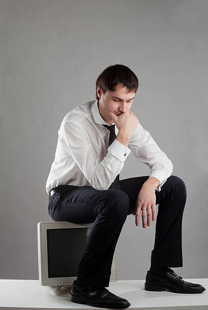 istock young man sitting on the monitor 154237097