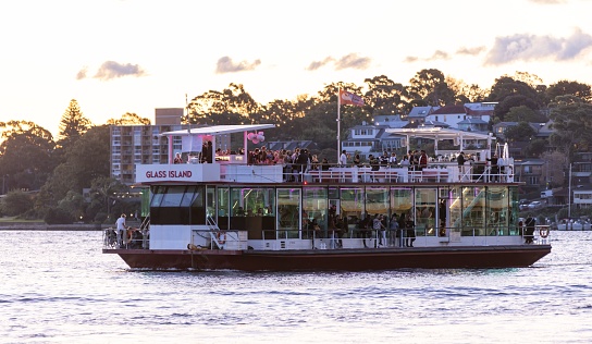 Sydney, Australia – April 16, 2023: A majestic tour boat sailing across a tranquil bay in Sydney, Australia, on a sunny day.