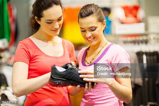 Shop Assistant Helping Customer Stock Photo - Download Image Now - Sports Shoe, Buying, Retail