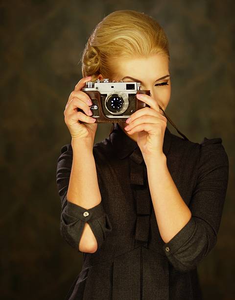 istock Woman in grey dress with retro camera. 154237448