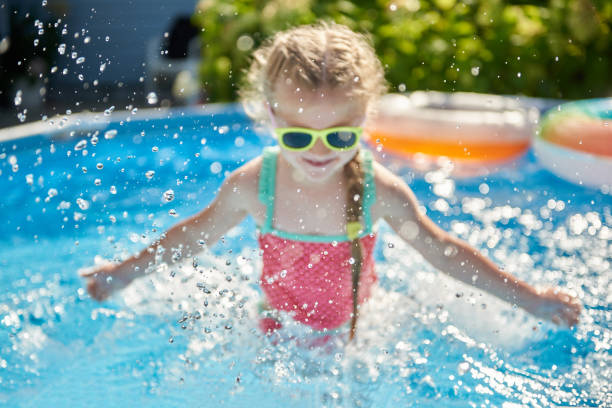 istock Abstract image with splashes of water as a child has fun swimming in a pool 1542377010
