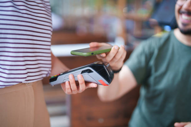 istock The man paying the restaurant bill with his mobile phone 1542401669