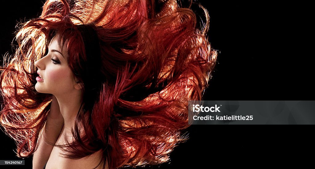 A beautiful woman with red hair A beautiful woman with crazy hair Black Background Stock Photo