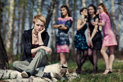 Group of girls discussing the other girl. Hatred, envy, or just a bad mood?