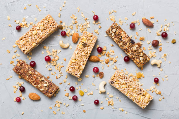 istock Various granola bars on table background. Cereal granola bars. Superfood breakfast bars with oats, nuts and berries, close up. Superfood concept 1542402211