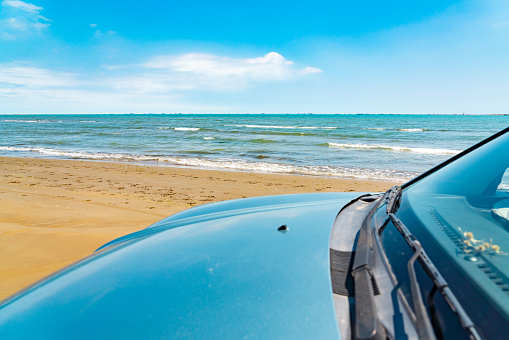 Summer vacation on sea beach with SUV car