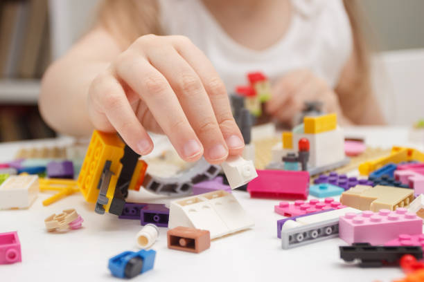 istock Child builds with constructor bricks, plays with toys, blurred background 1542412859