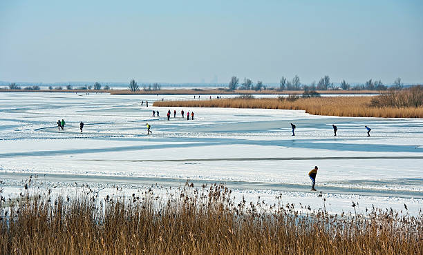 istock People skating on a frozen lake in winter 154242005