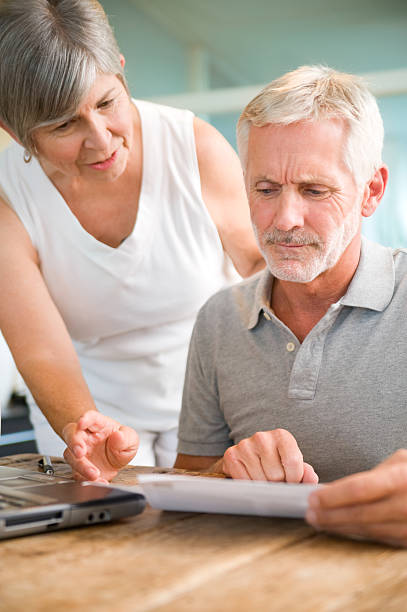 Senior couple looking over papers stock photo