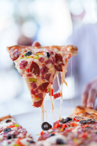 Appetizing slice of pizza with melting cheese