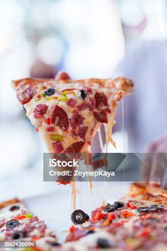 istock Appetizing slice of pizza with melting cheese 1542420094