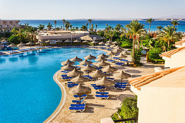 pool, beach umbrellas and the Red Sea in Egypt stock photo