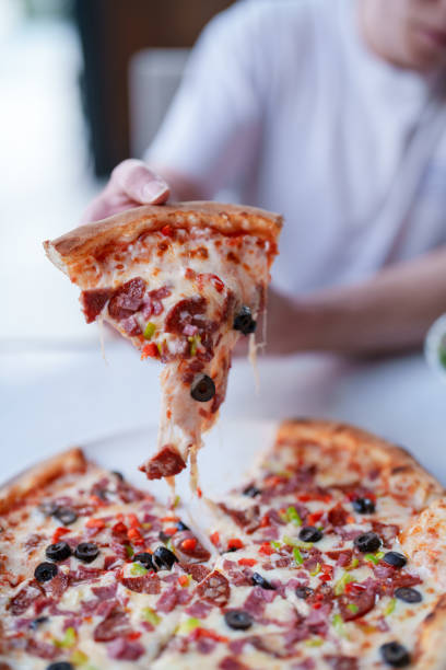 istock Appetizing slice of pizza with melting cheese 1542423591