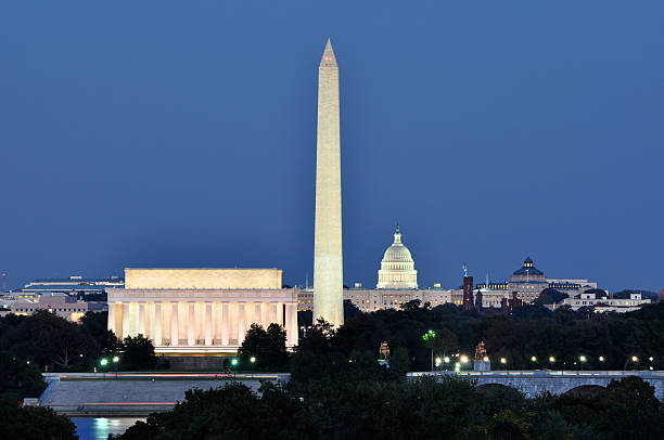 Washington, DC, skyline at night Washington DC skyline including Lincoln Memorial, Washington Monument and US Capitol building as seen from Arlington,Virginia. national monument stock pictures, royalty-free photos & images