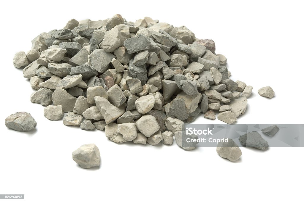 A pile of small pebbles and rocks Pale of crushed stone isolated on white Stone - Object Stock Photo