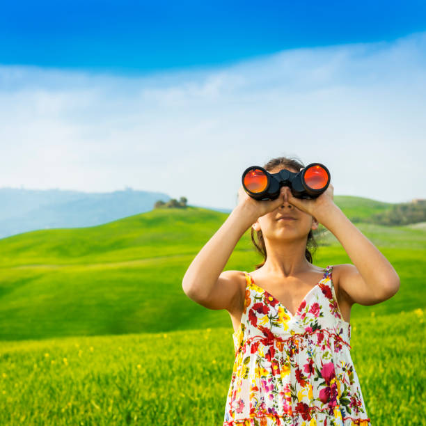 istock Little girl exploring with binoculars in Tuscany -Italy 154245846