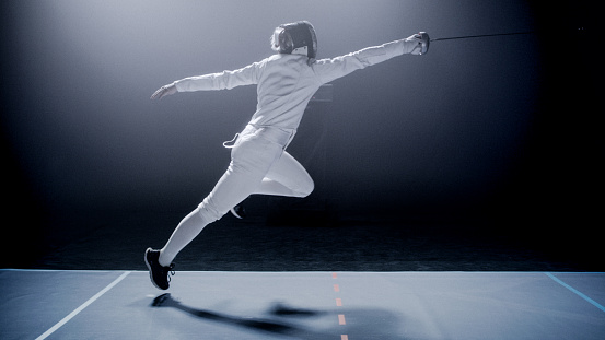 Professional fencer practice in full gear