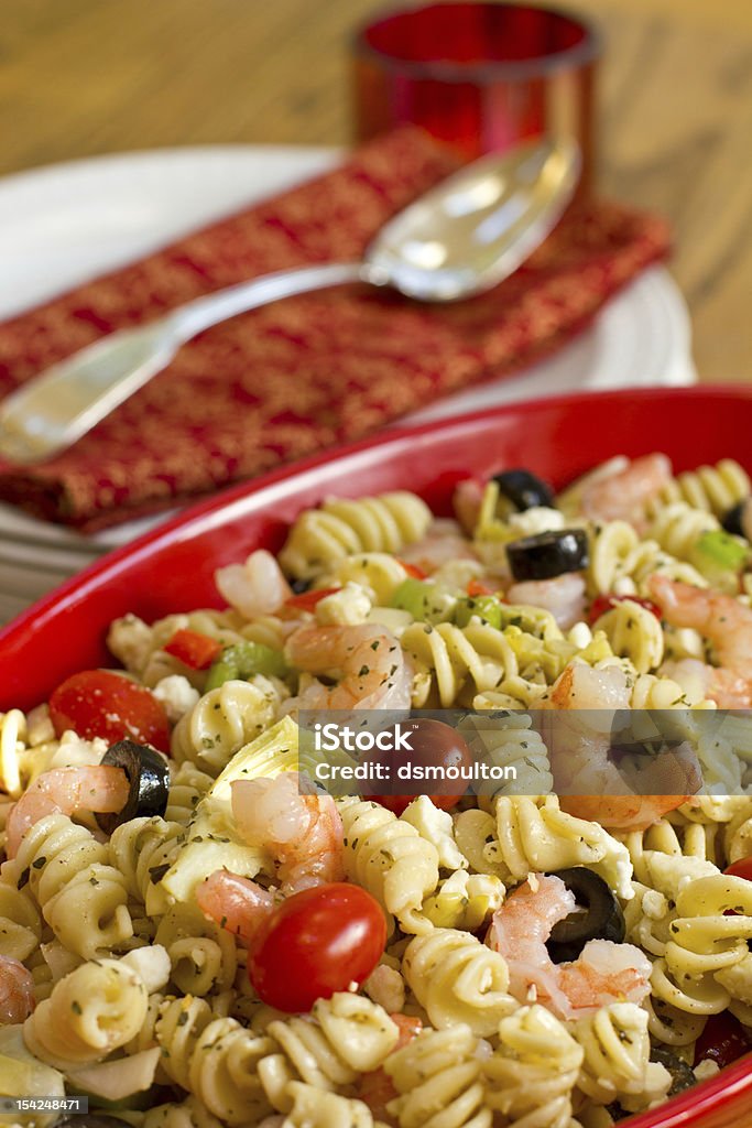 Shrimp Pasta Salad A pasta salad made with shrimp, tomatoes, olives, artichokes, feta cheese, celery, and onion tossed with Greek salad dressing Pasta Salad Stock Photo