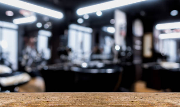 istock Barber shop background with blur, wooden table upfront. Empty space for decoration and advertising products. 1542485864