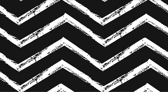 Hand drawn vector abstract rough geometric monochrome seamless zig zag chevron pattern in black and white colors.Hand made grunge brush painted texture.Scandinavian concept design for fashion,fabric.