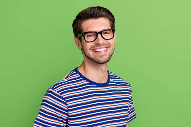 istock Closeup portrait of optimistic young guy remote working programmer wear striped trendy t shirt glasses isolated on green color background 1542522280
