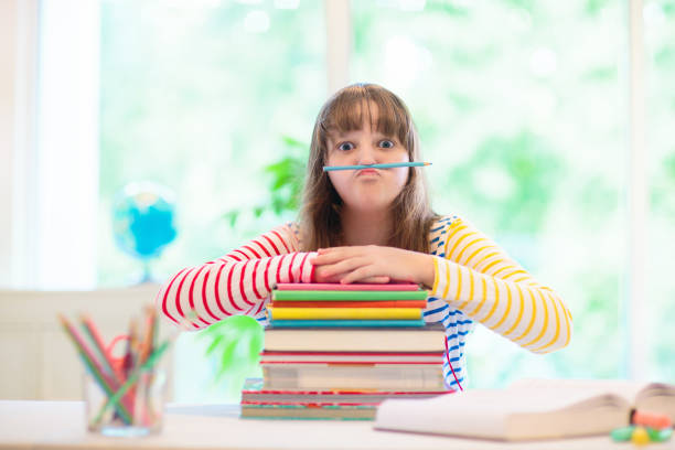 istock Child with books doing homework after school. 1542564110