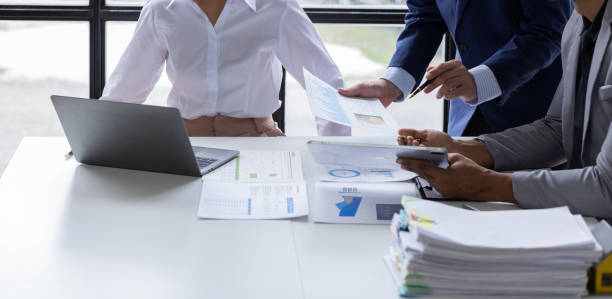 istock Team of Business people working at workplace with tablet and document, doing planning analyzing Tax financial report, business plan investment, finance analysis Economic business discussions. 1542565556