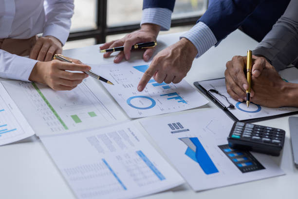 istock Team of Business people working at workplace with tablet and document, doing planning analyzing Tax financial report, business plan investment, finance analysis Economic business discussions. 1542565577