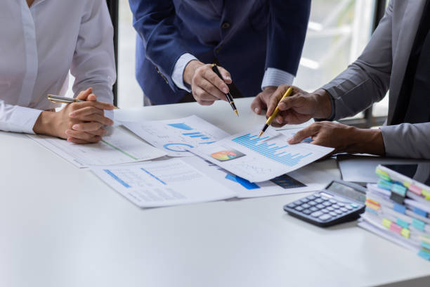 istock Team of Business people working at workplace with tablet and document, doing planning analyzing Tax financial report, business plan investment, finance analysis Economic business discussions. 1542565591
