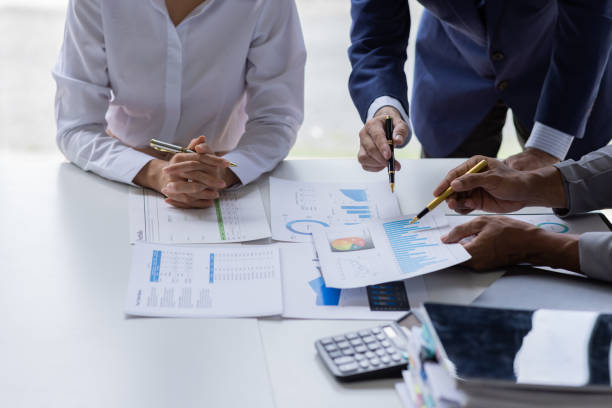istock Team of Business people working at workplace with tablet and document, doing planning analyzing Tax financial report, business plan investment, finance analysis Economic business discussions. 1542565594