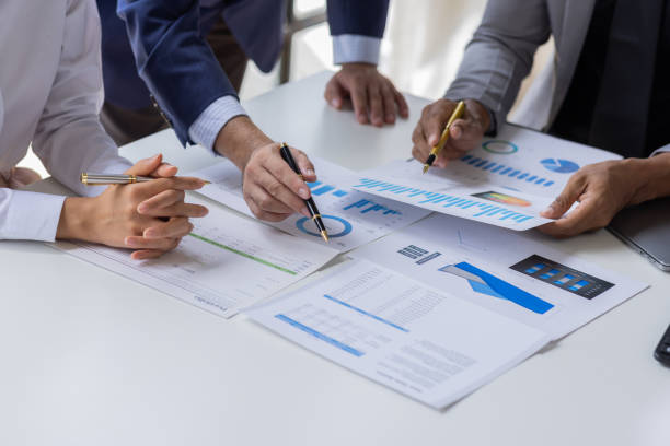 istock Team of Business people working at workplace with tablet and document, doing planning analyzing Tax financial report, business plan investment, finance analysis Economic business discussions. 1542565595