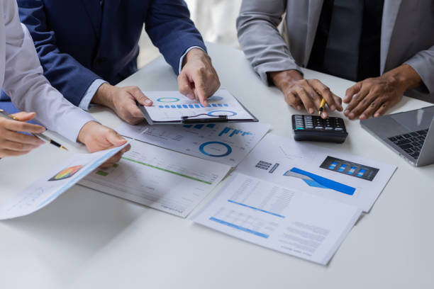 istock Team of Business people working at workplace with tablet and document, doing planning analyzing Tax financial report, business plan investment, finance analysis Economic business discussions. 1542565620
