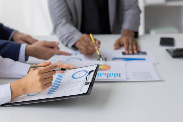 istock Team of Business people working at workplace with tablet and document, doing planning analyzing Tax financial report, business plan investment, finance analysis Economic business discussions. 1542565642