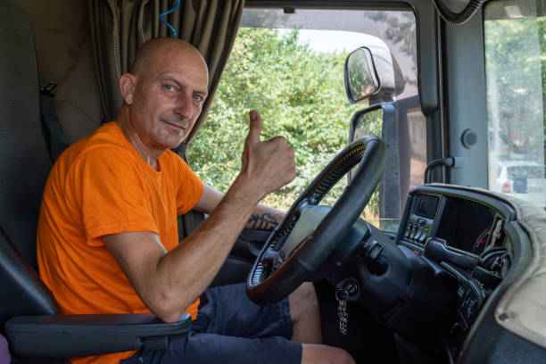 istock A big truck driver with his truck. 1542565986