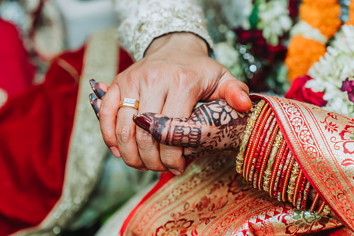 Newlywed couple holding hands together, Bride and Groom Hands