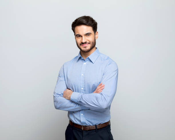 young businessman smiling at camera - affärsman bildbanksfoton och bilder