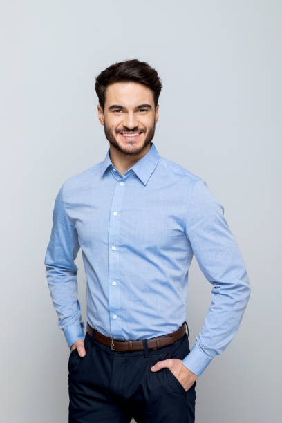 istock Young businessman smiling at camera 1542566140