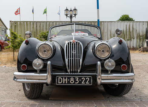 Lelystad, The Netherlands, 18.06.2023, Front view of classic sports car Jaguar XK 140  from 1955 at The National Oldtimer Day