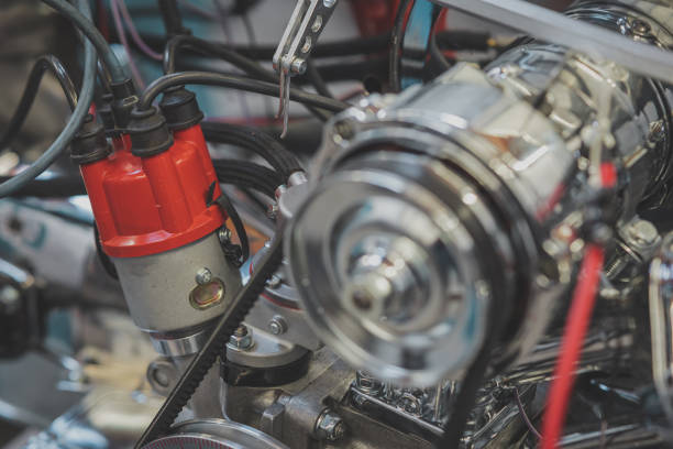 istock Distributor and distributor cap of a vintage car, visible ignition cables of a four cylinder engine of older type. Racing engine being built with emphasis on distributor. 1542570708