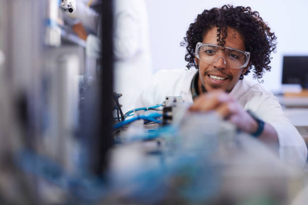 istock Happy black scientist working on production line in a lab. 1542574989
