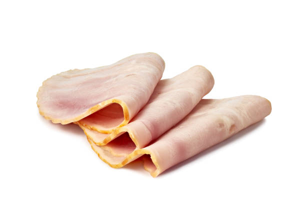istock Three rolled slices of ham on a white background 1542576073